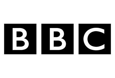 A person using a zimmer frame is assisted by another standing person. Both are shown in a simple black-and-white line drawing.
